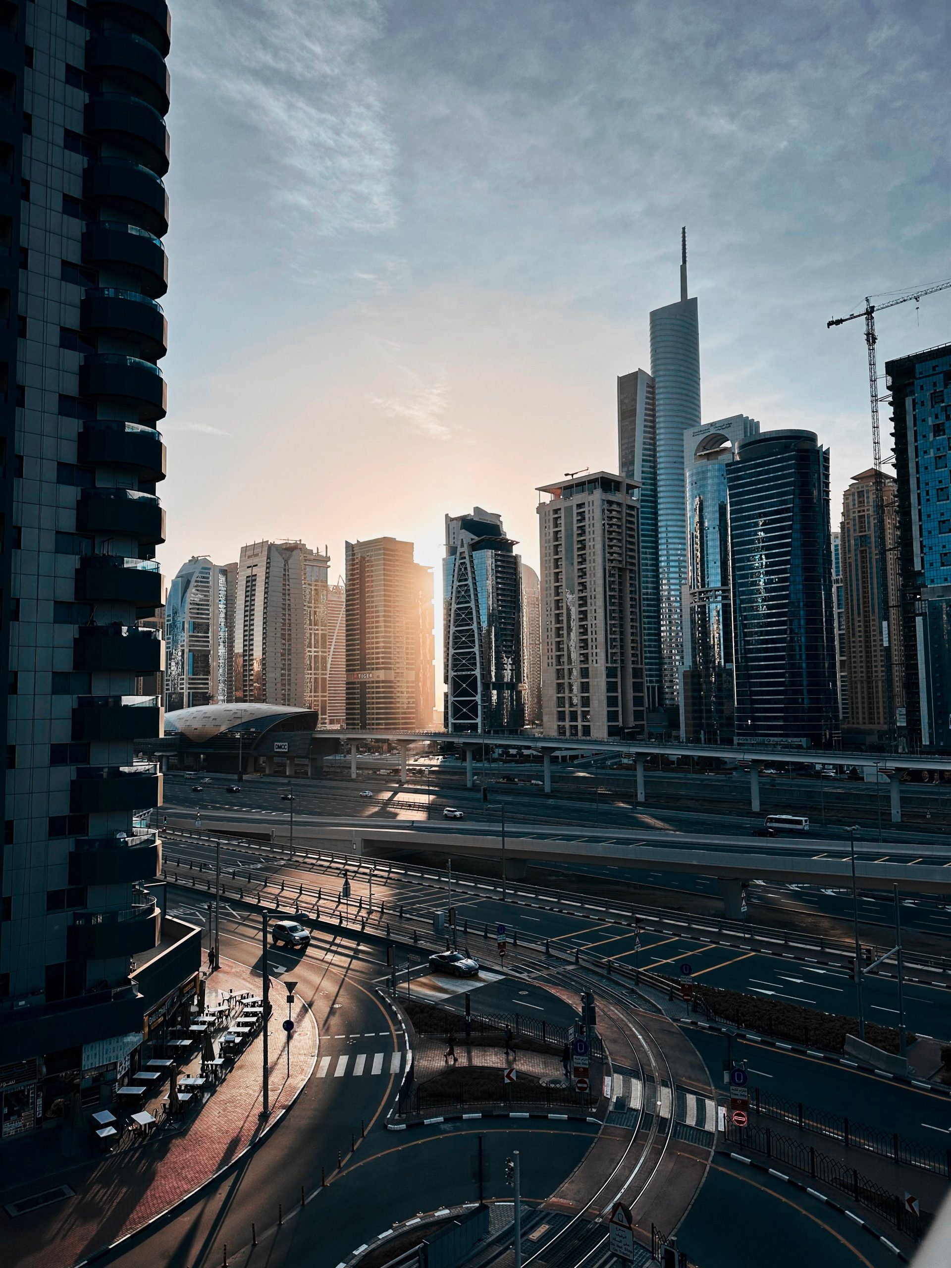 Captivating view of Dubai's modern skyline with skyscrapers at sunrise, showcasing urban architecture.