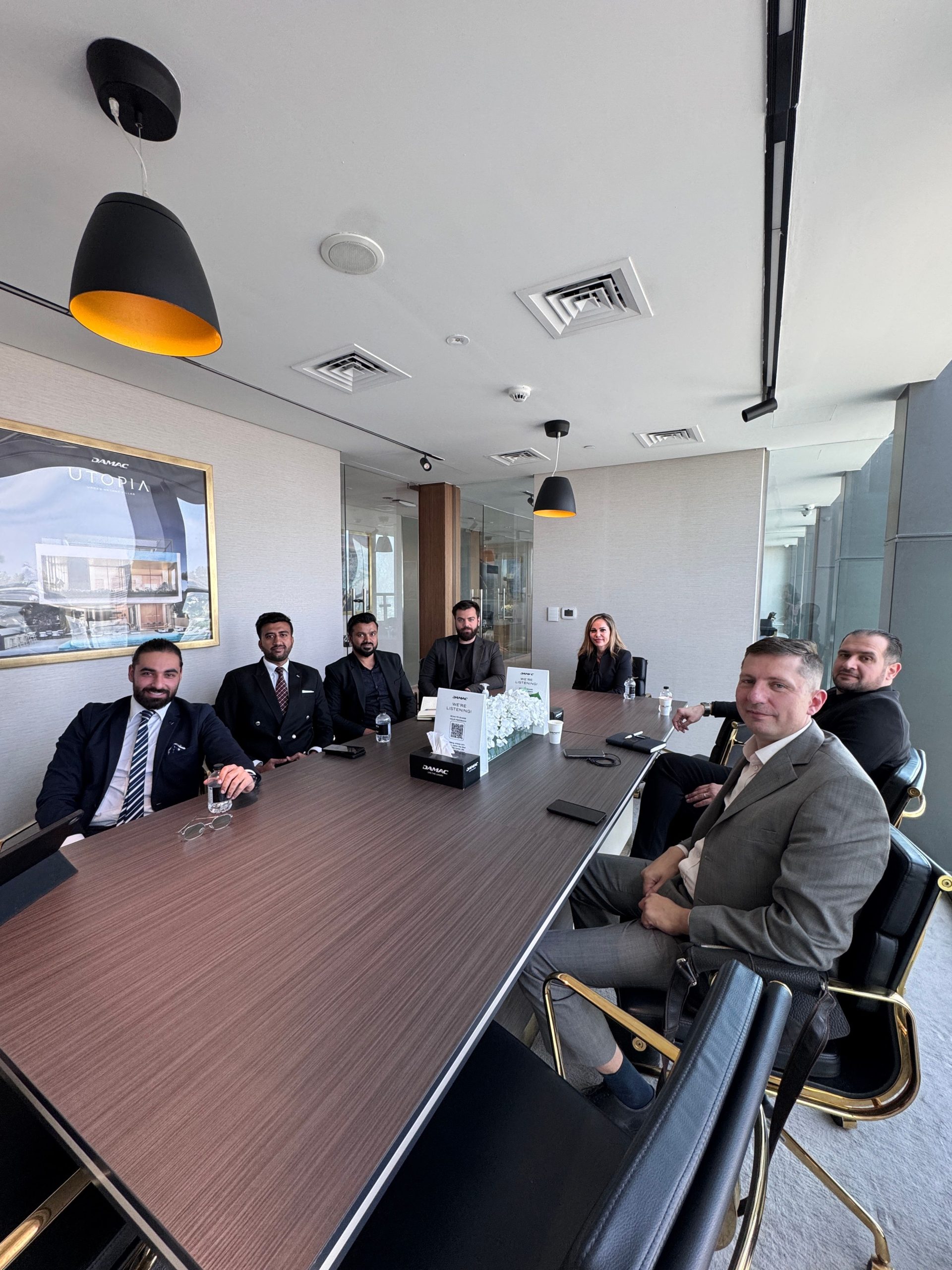 Business professionals in a formal meeting at a modern conference room.